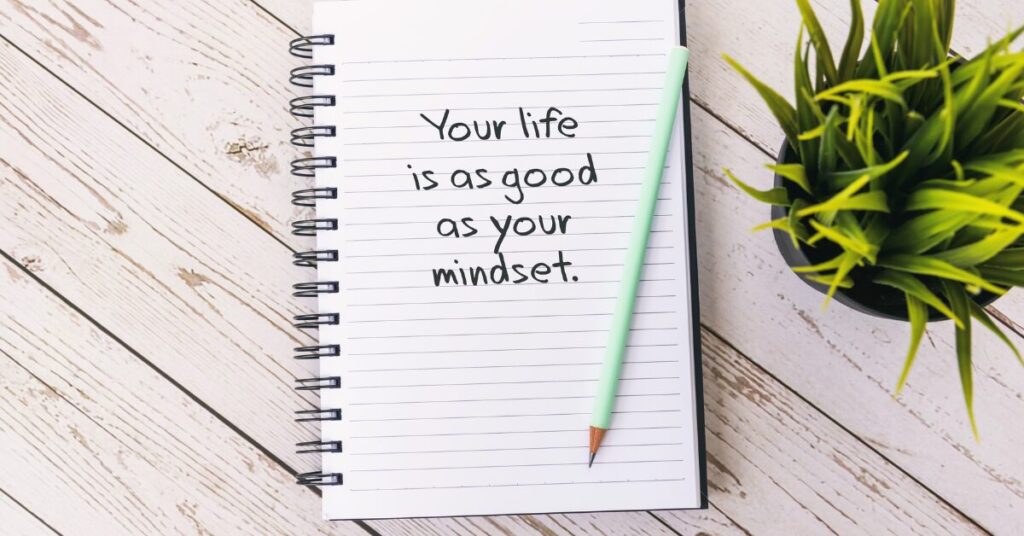a graphic of a notepad with writing on it that says your life is as good as your mindset to depict that your mindset can change your life